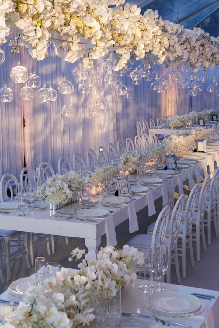 The Grand Ballroom at Aurum Sky dressed in white florals, glass orbs and candlelight