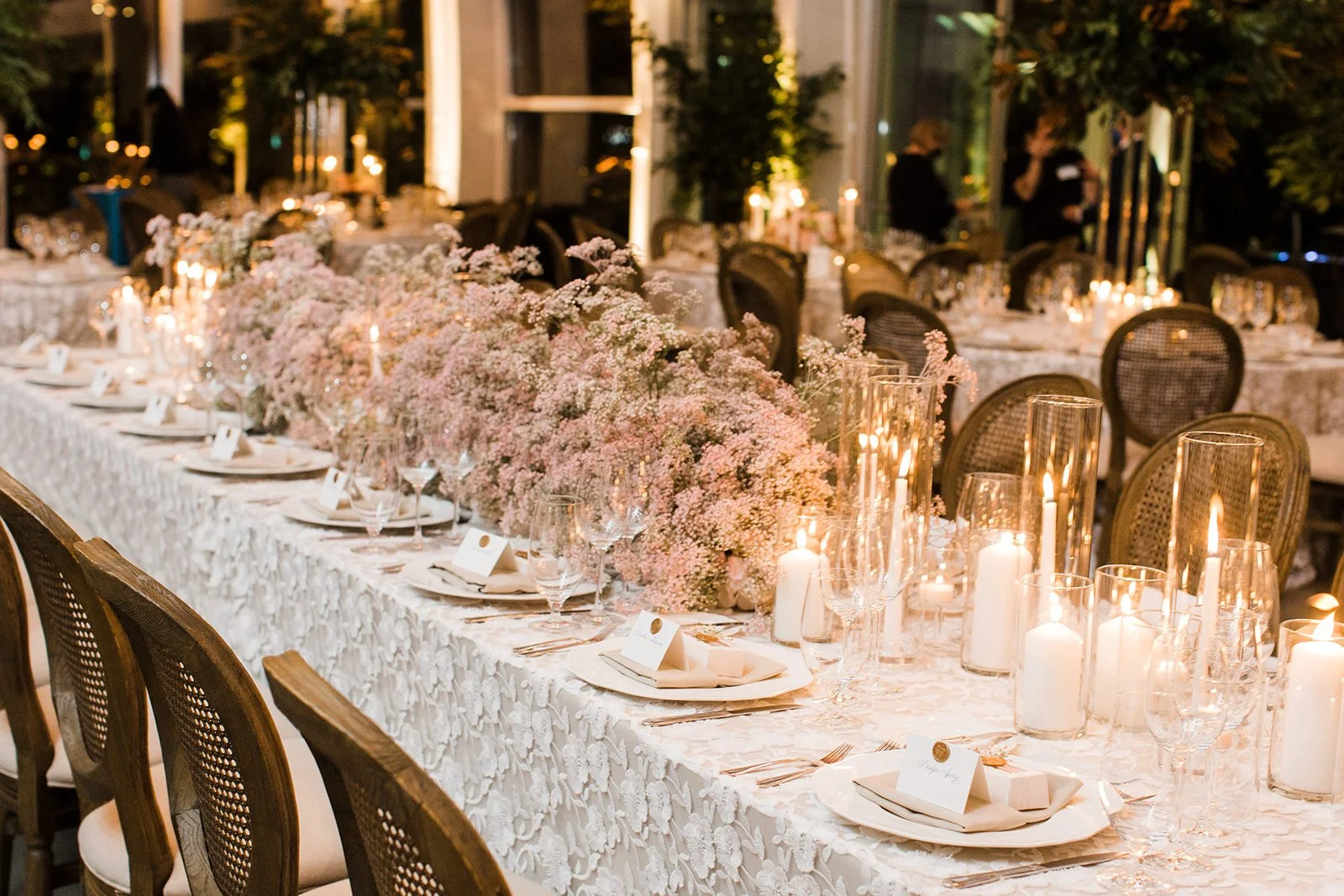 Candlelit reception table with soft florals and place settings