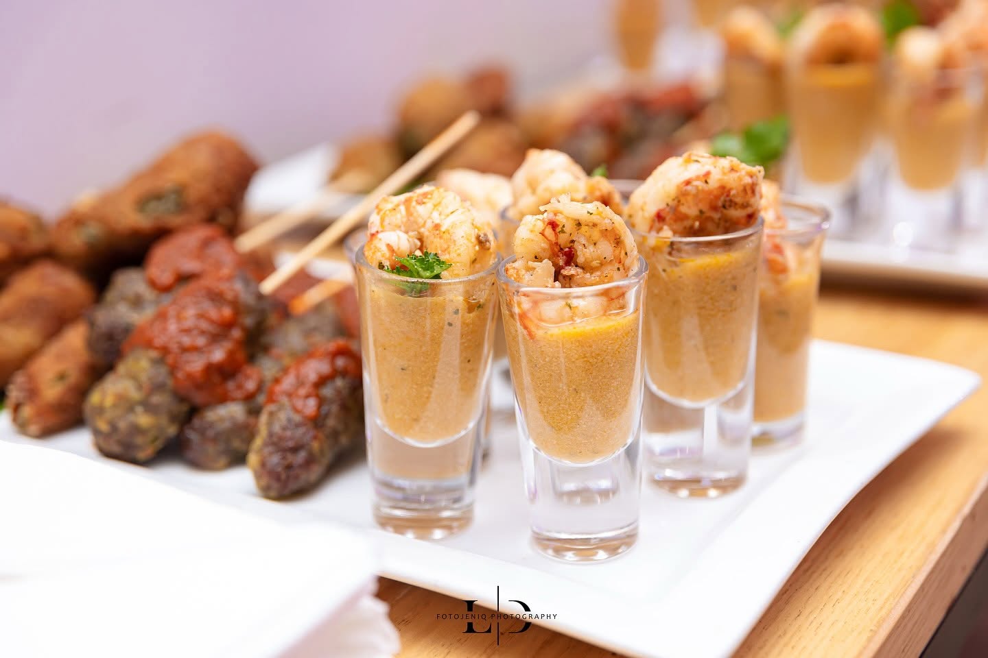 Canapes and prawn shooters plated for a garden reception